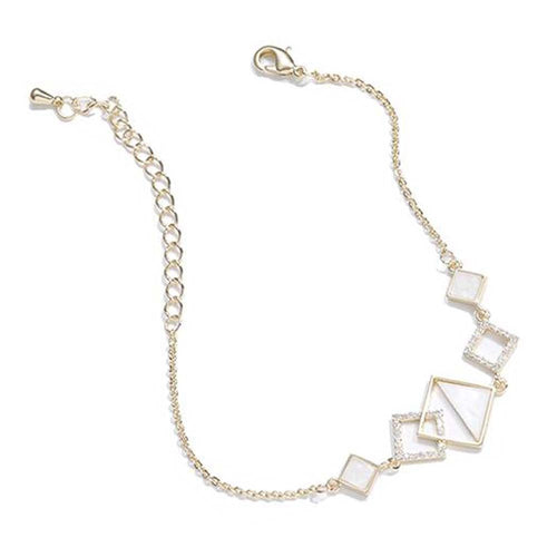 Gold bracelet with square-shaped charms on a white background