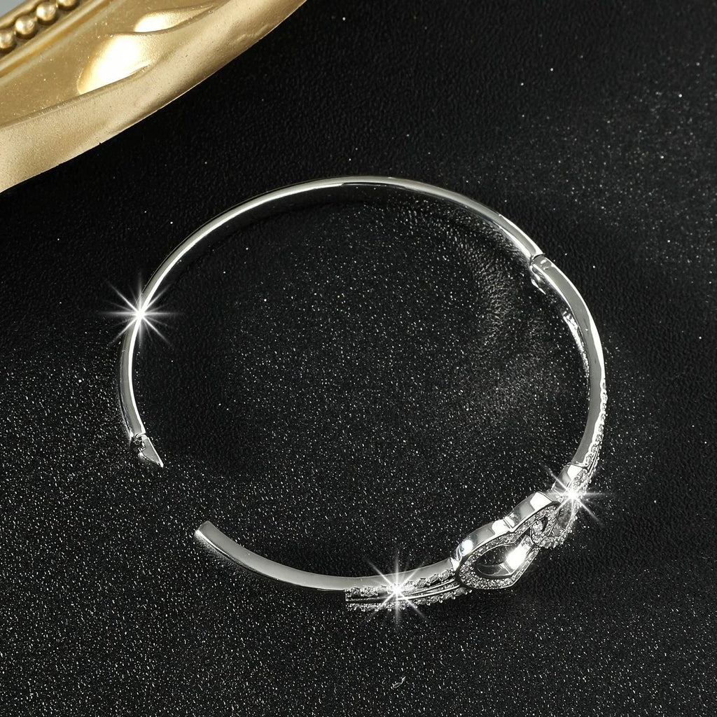 Silver bracelet with decorative elements on a black background