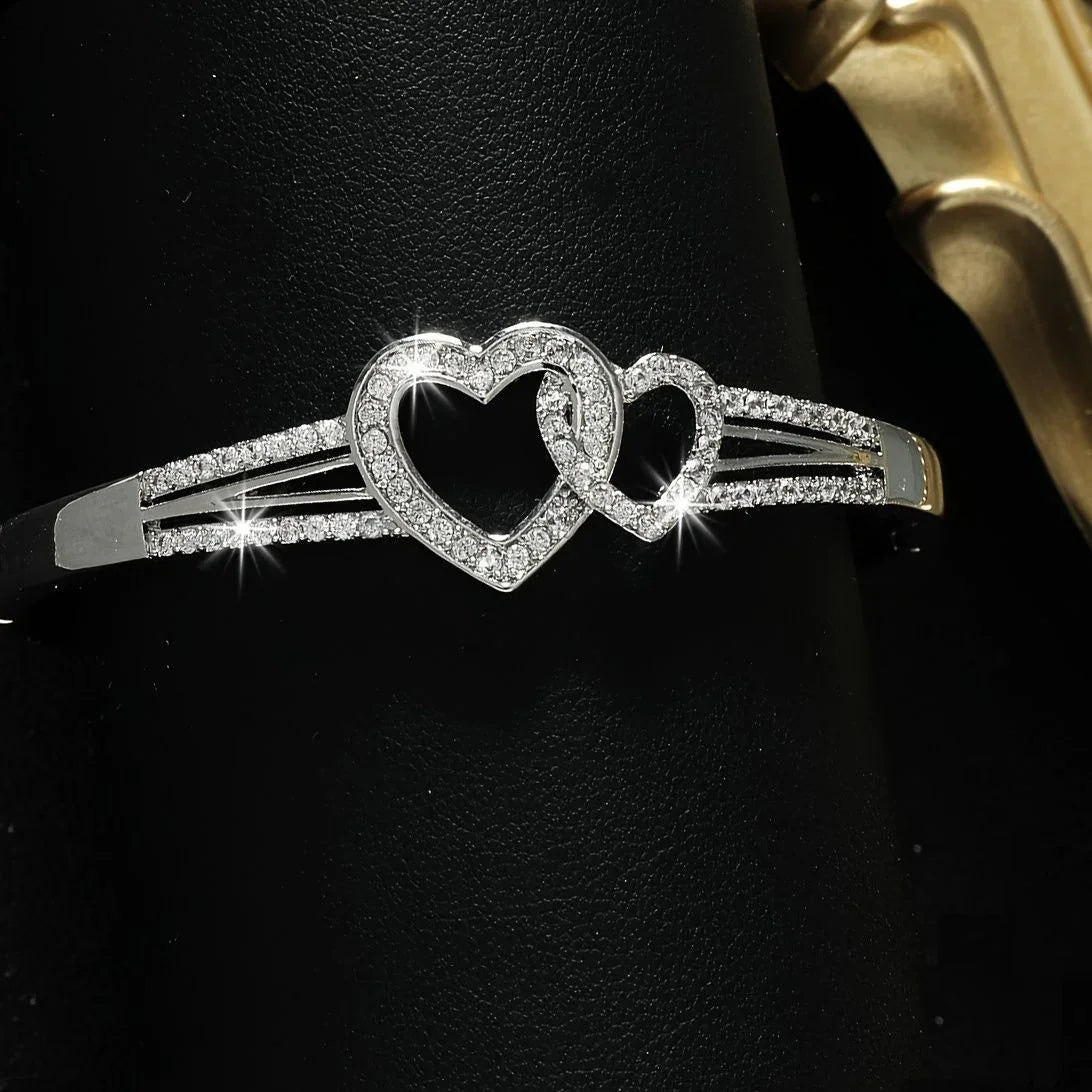 Silver hair comb with heart design on a black background