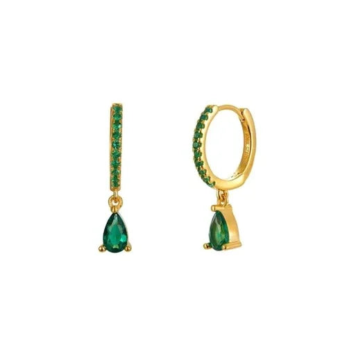 Gold earrings with green gemstones on a white background
