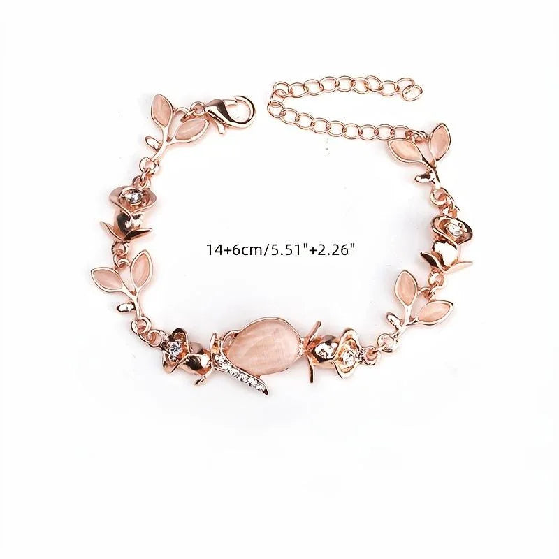 Rose gold bracelet with floral designs on a white background