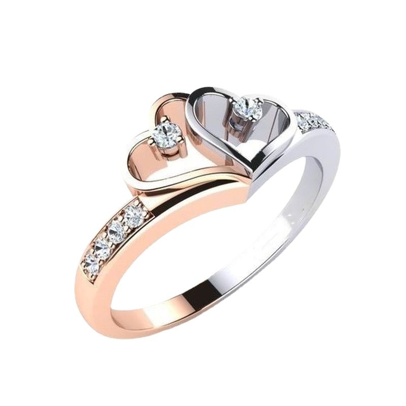 Two-tone heart-shaped ring with diamonds on a white background