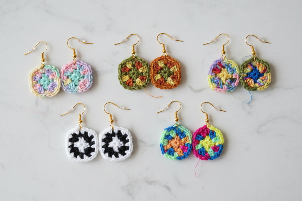 Colorful crochet earrings on a marble surface